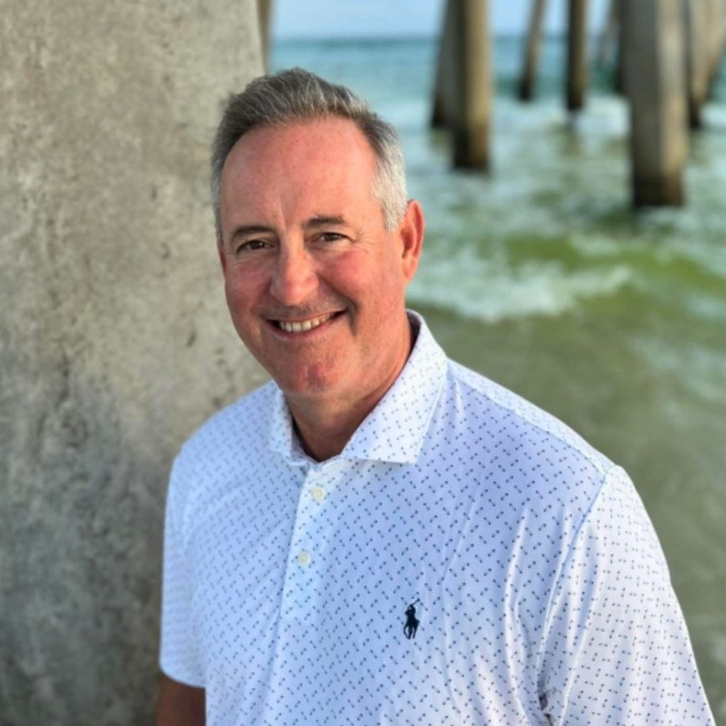 Terry Childers smiling by the beach