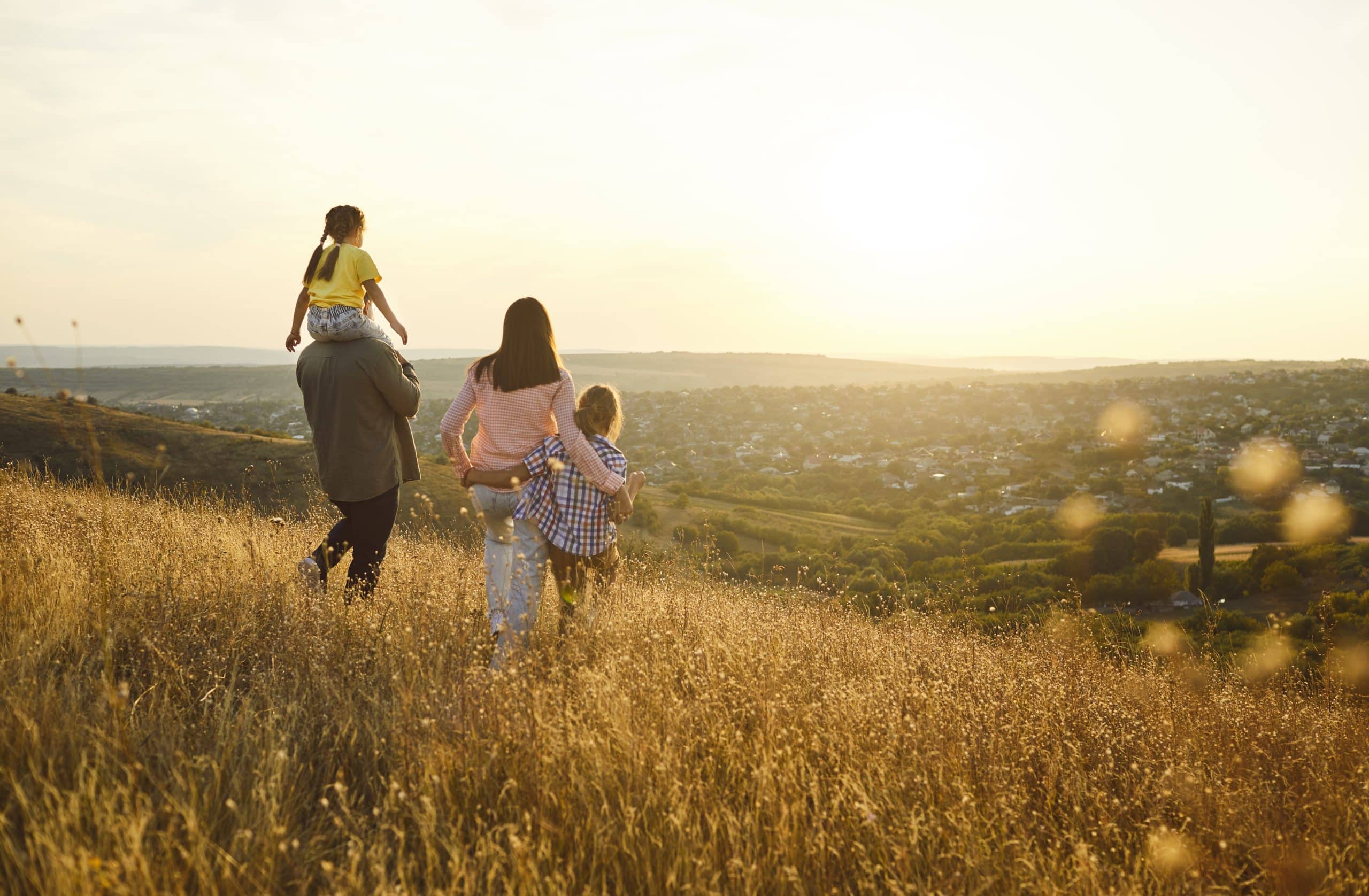 Family walking in the field after receiving a detox assessment.