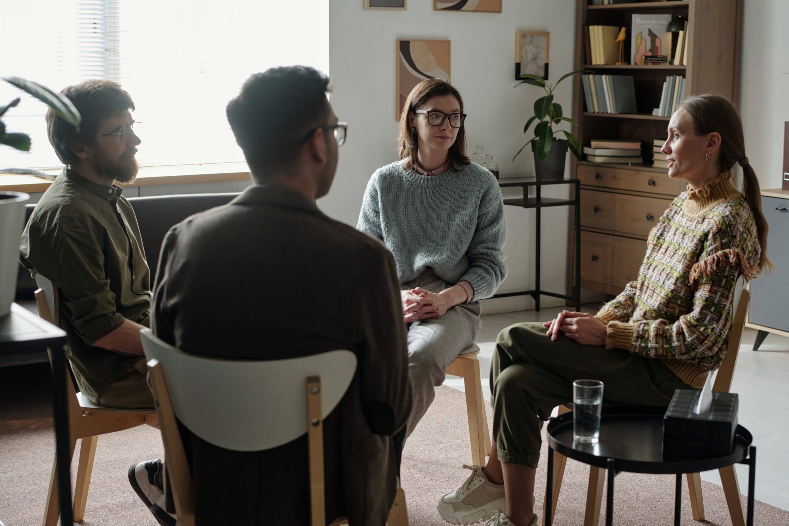 Group of people talking in therapy at detox greensboro.